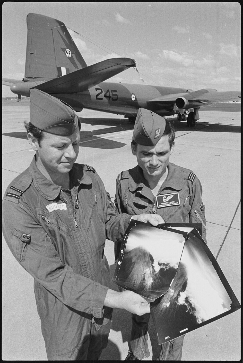 Two airmen with photo prints at RAAF Base Amberley, Amberley, October 1980