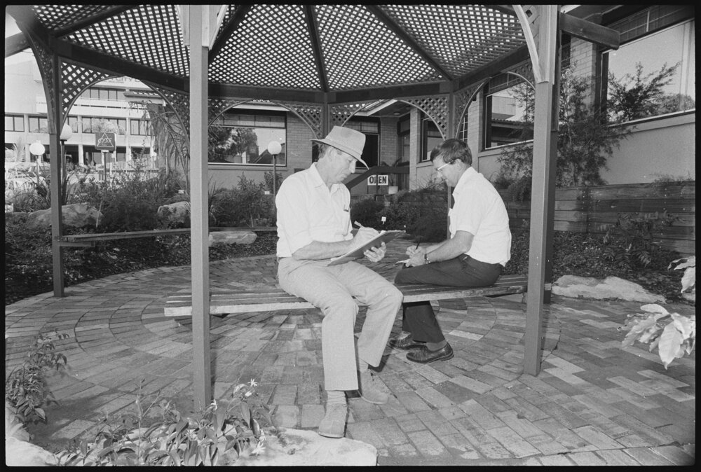 Two unidentified men in a gazebo outside the Ipswich Community Youth Support Scheme (CYSS) offices, Ipswich, September 1987