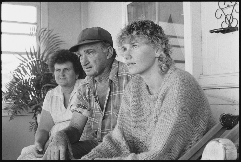 Three unidentified people on the verandah of a timber house, Ipswich, September 1987