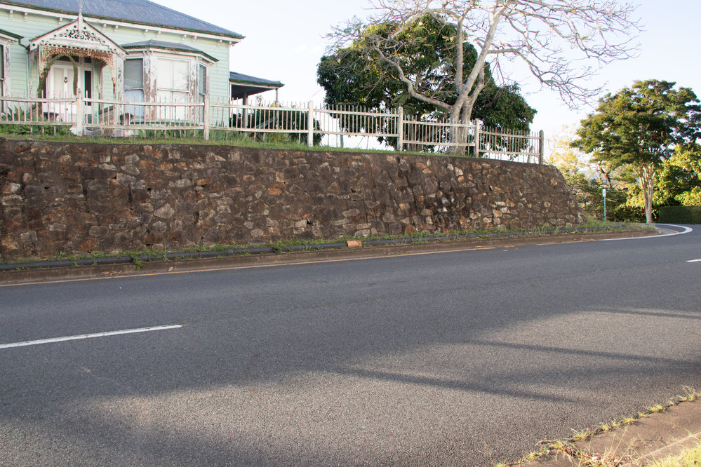 Retaining wall and above ground pipe in front of 'Caloola', former home of Mayor John Macfarlane, 1 Deebing Street, Ipswich, September 2022