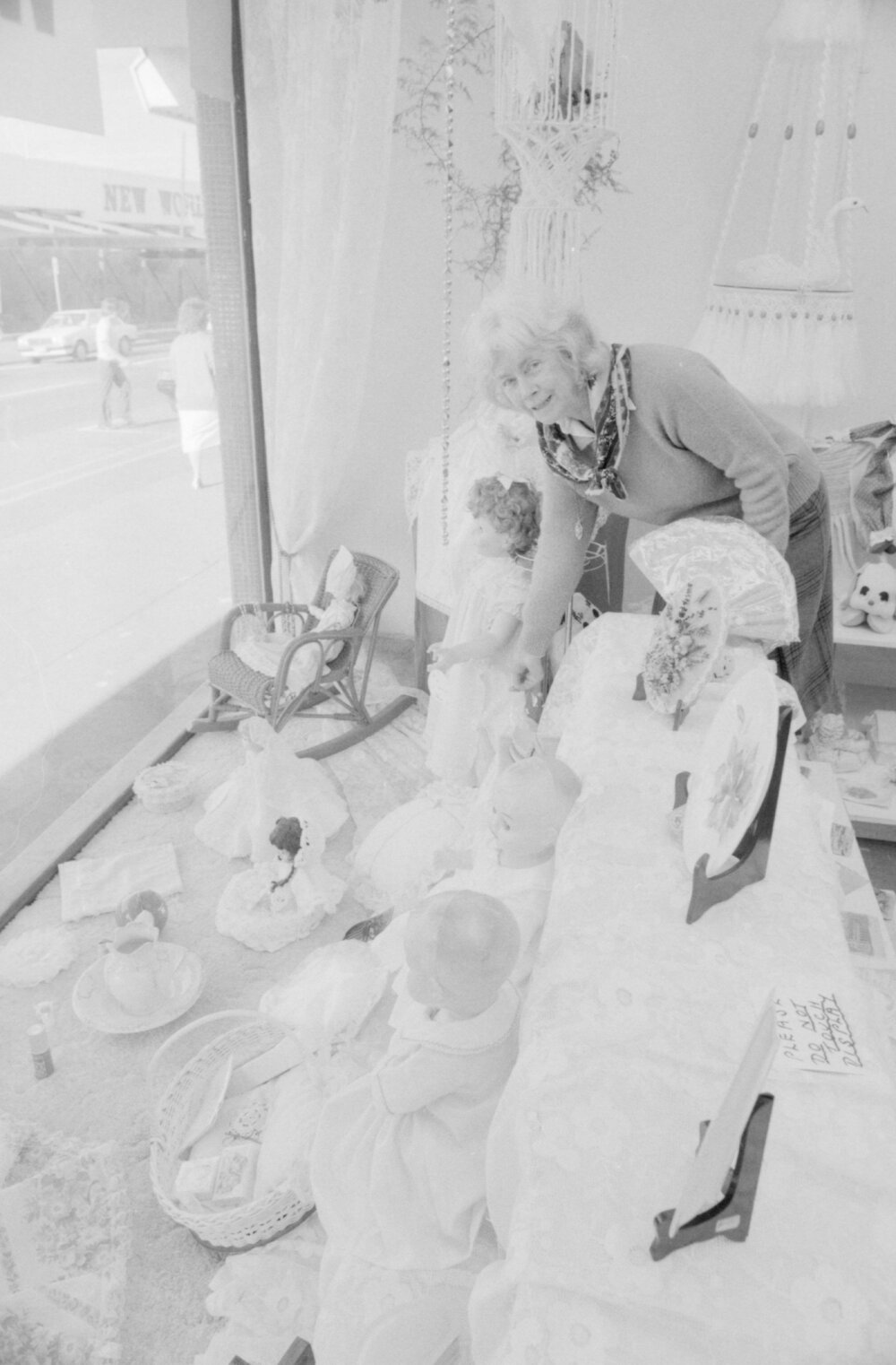 Unidentified woman preparing a shop front on Brisbane Street opposite of Coles New World, Ipswich, August 1987