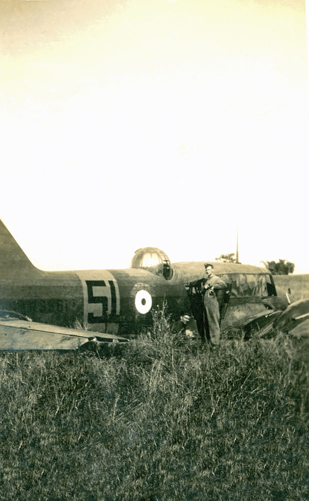 Doug Titmarsh, from Amberley Air Force Base, Ipswich, with crashed Avro Anson aircraft, Gympie, 1941