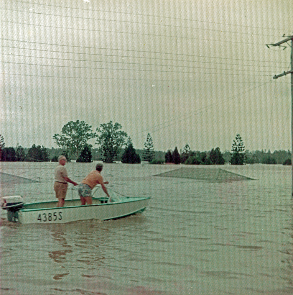 Men in a boat on flooded Woogaroo Street, Goodna, Ipswich, 1974