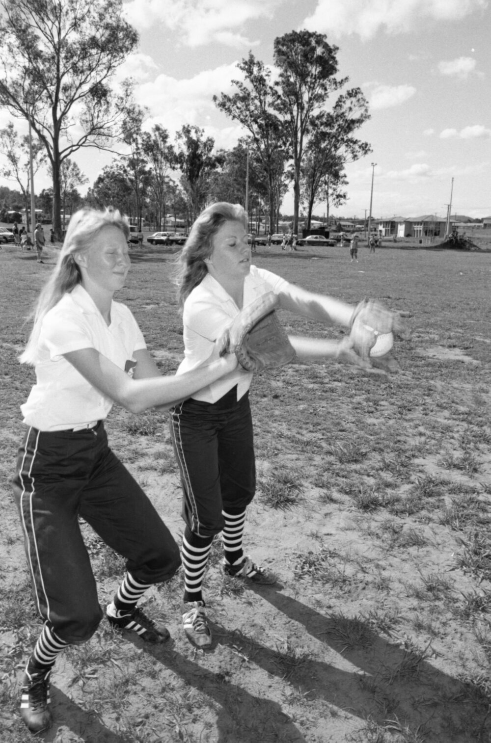 Unidentified Bombers Softball Club players practicing in a park, Ipswich, Queensland, January 1978