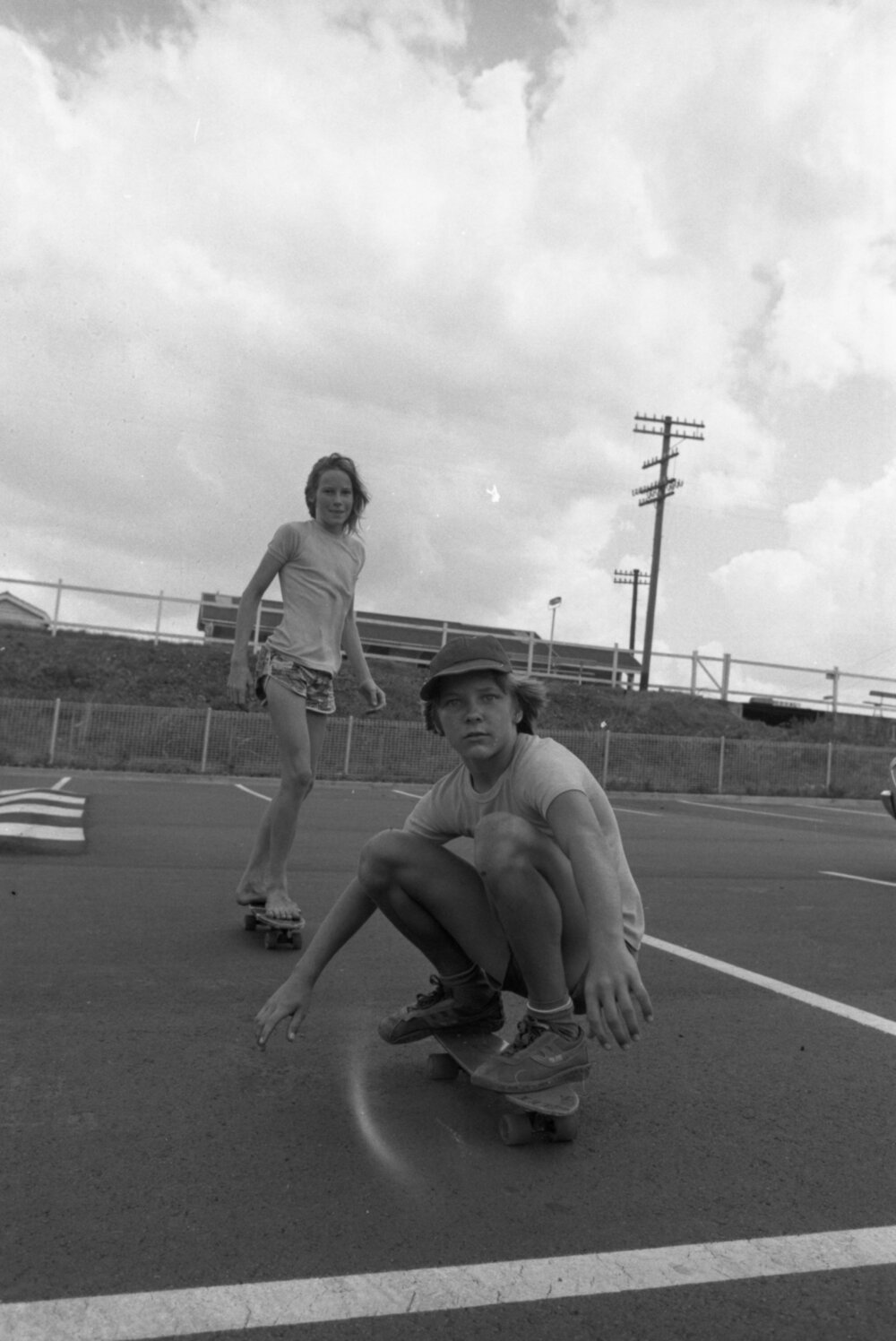 Children skateboarding in a car park, Ipswich, Queensland, January 1978