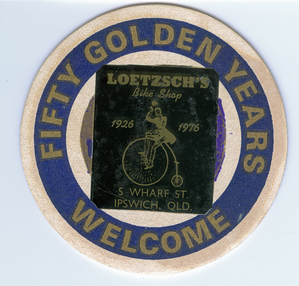 Coaster of Vic Loetzsch Bike Shop, celebrating 50 years, Ipswich, 1976