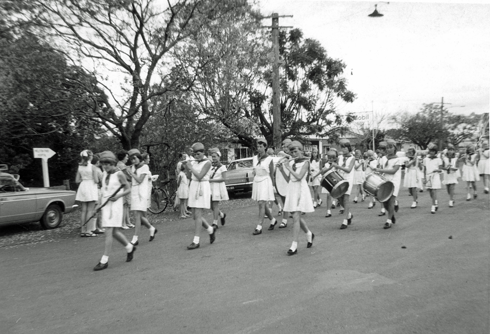 Thought to be a school band in procession, Goodna, Ipswich, late 1960s