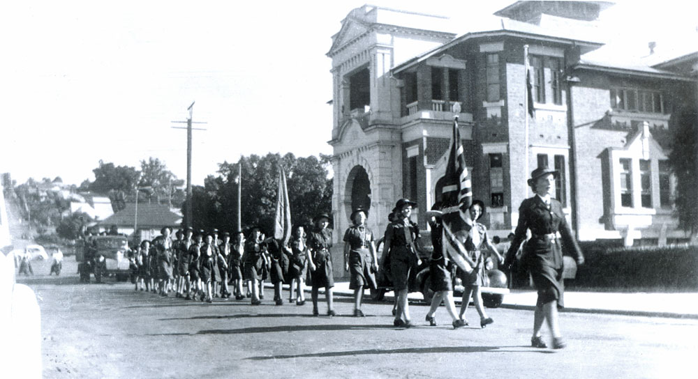 Girl Guides marching past the Soldiers' Memorial Hall, Ipswich, 1949