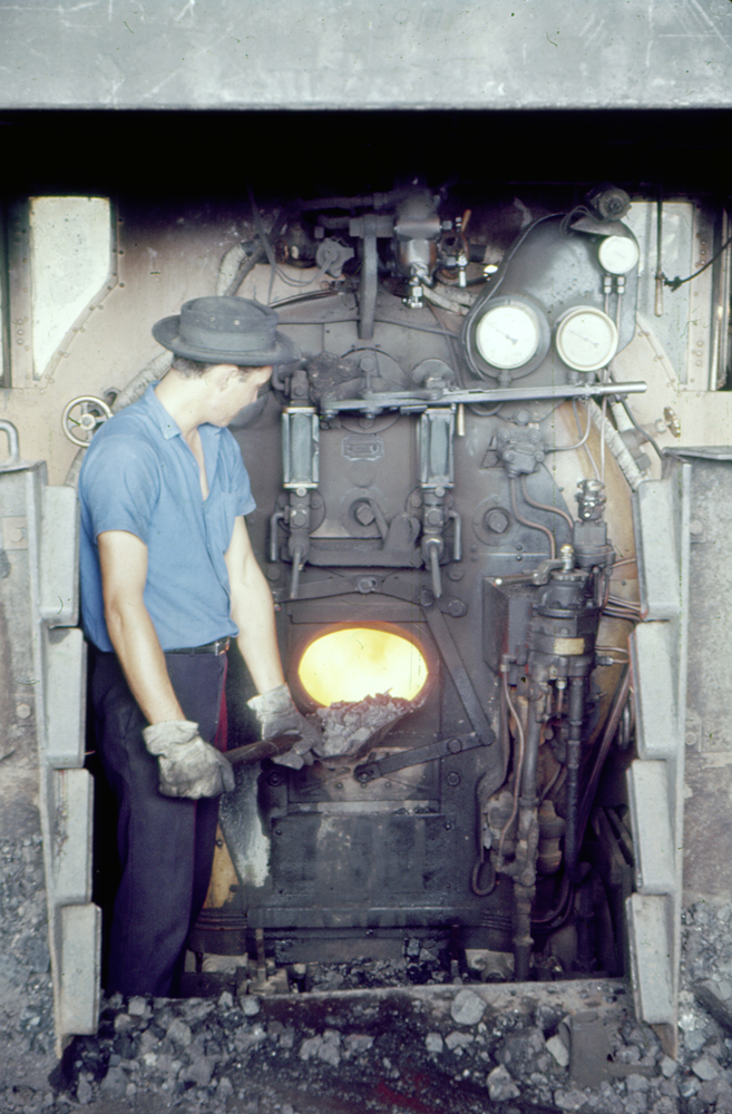 Fireman stoking boiler at Ipswich Railway Workshops Roundhouse, North Ipswich, 1969
