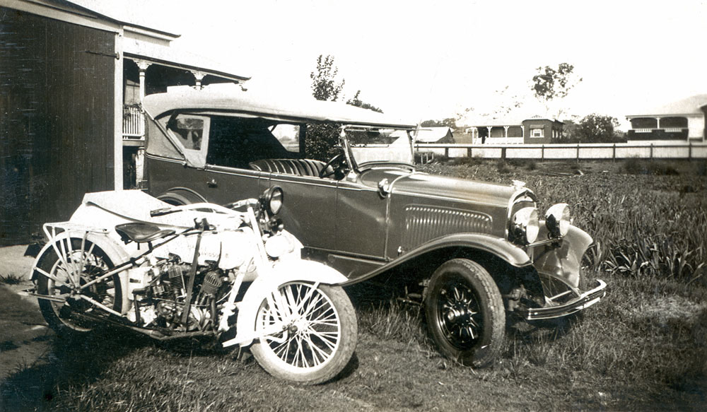 Ford motor car and Harley-Davidson in the backyard at North Ipswich, c.1935