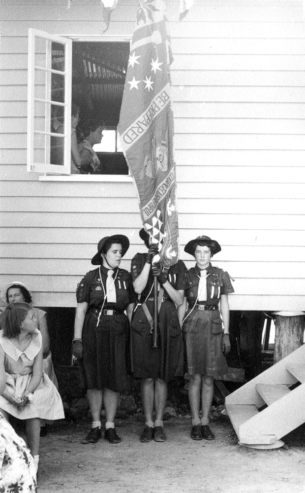 Guides holding flag, at the opening of the guide hut in Queens Park, Ipswich, 1947