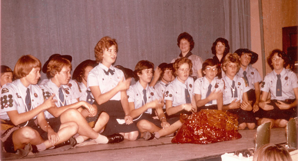 1st &amp; 5th Ipswich Girl Guides singing around the 'campfire', Silkstone, Ipswich, 1963