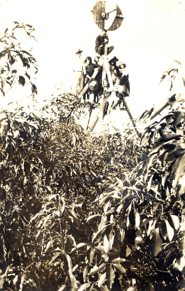 Group of people from Redbank Plains climbing Trig station at Spring Mountain, 1920s