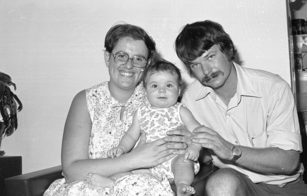 Unidentified man, woman, and baby, Ipswich, December 1977