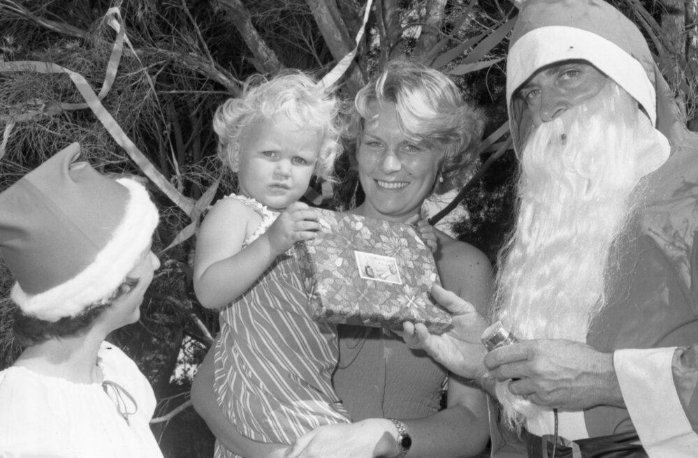 Santa giving children presents, Ipswich, December 1977