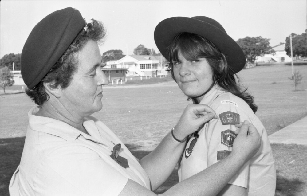 Unidentified woman badging a Girl Guide, Ipswich, December 1977