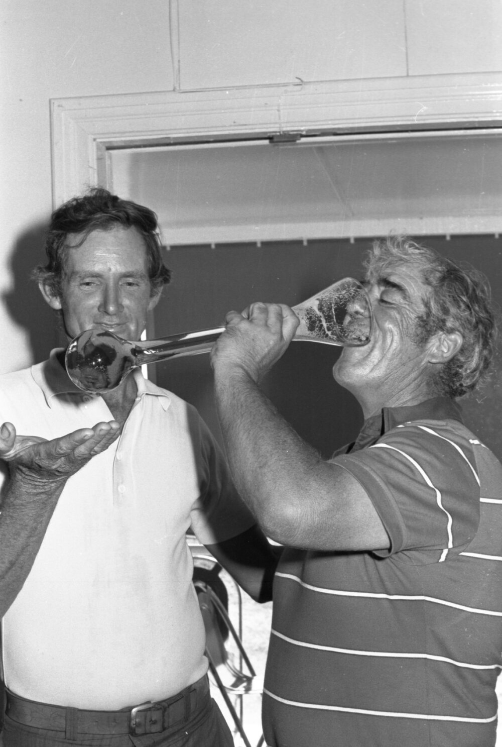 Golf players drinking beer out of a yard glass, Ipswich, December 1977