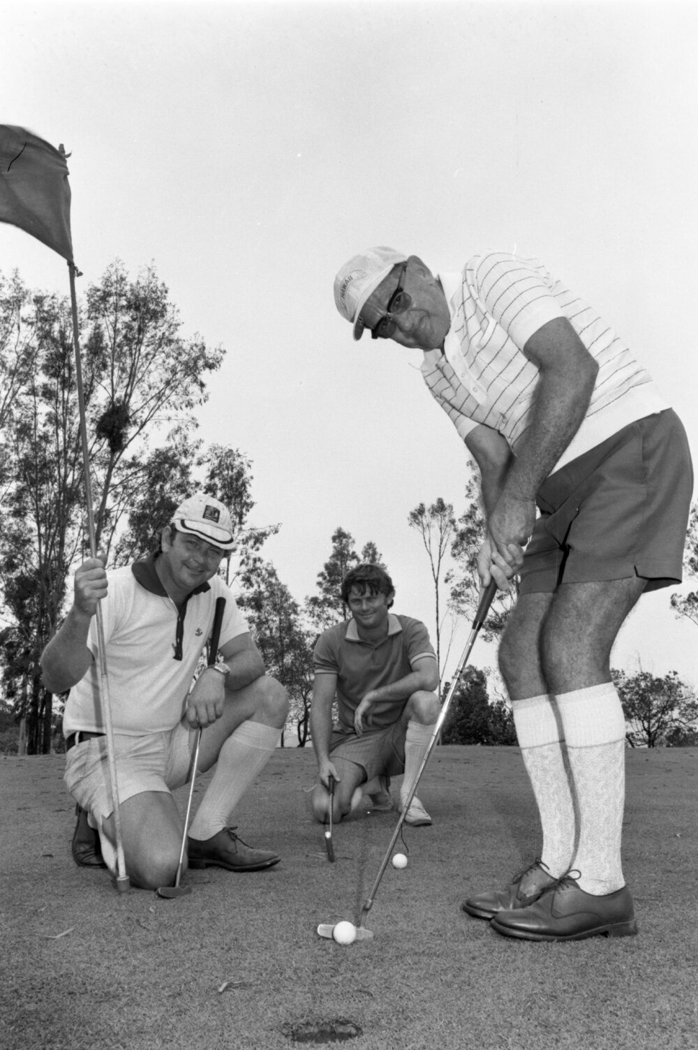 Three golfers during a putt, Ipswich, January 1978