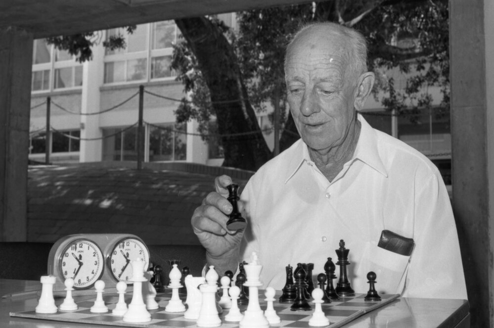 Unidentified man playing chess outdoors, Ipswich, January 1978