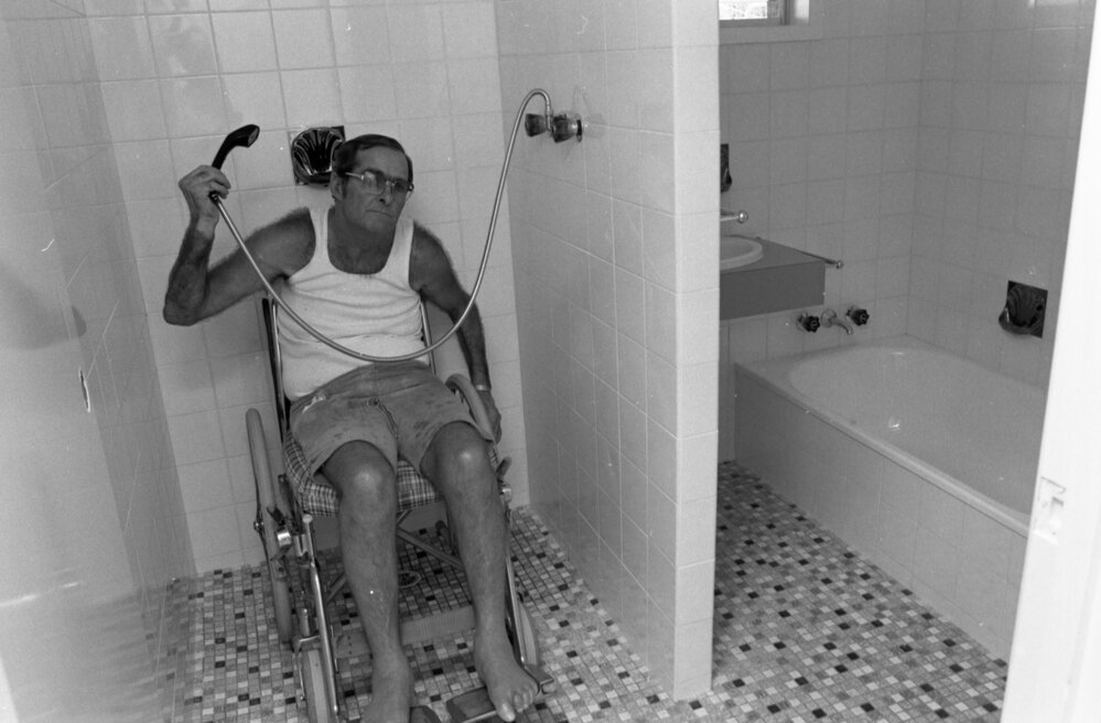 Man with paraplegia gives tour of bathroom in his accessible home, Ipswich, Queensland, January 1978