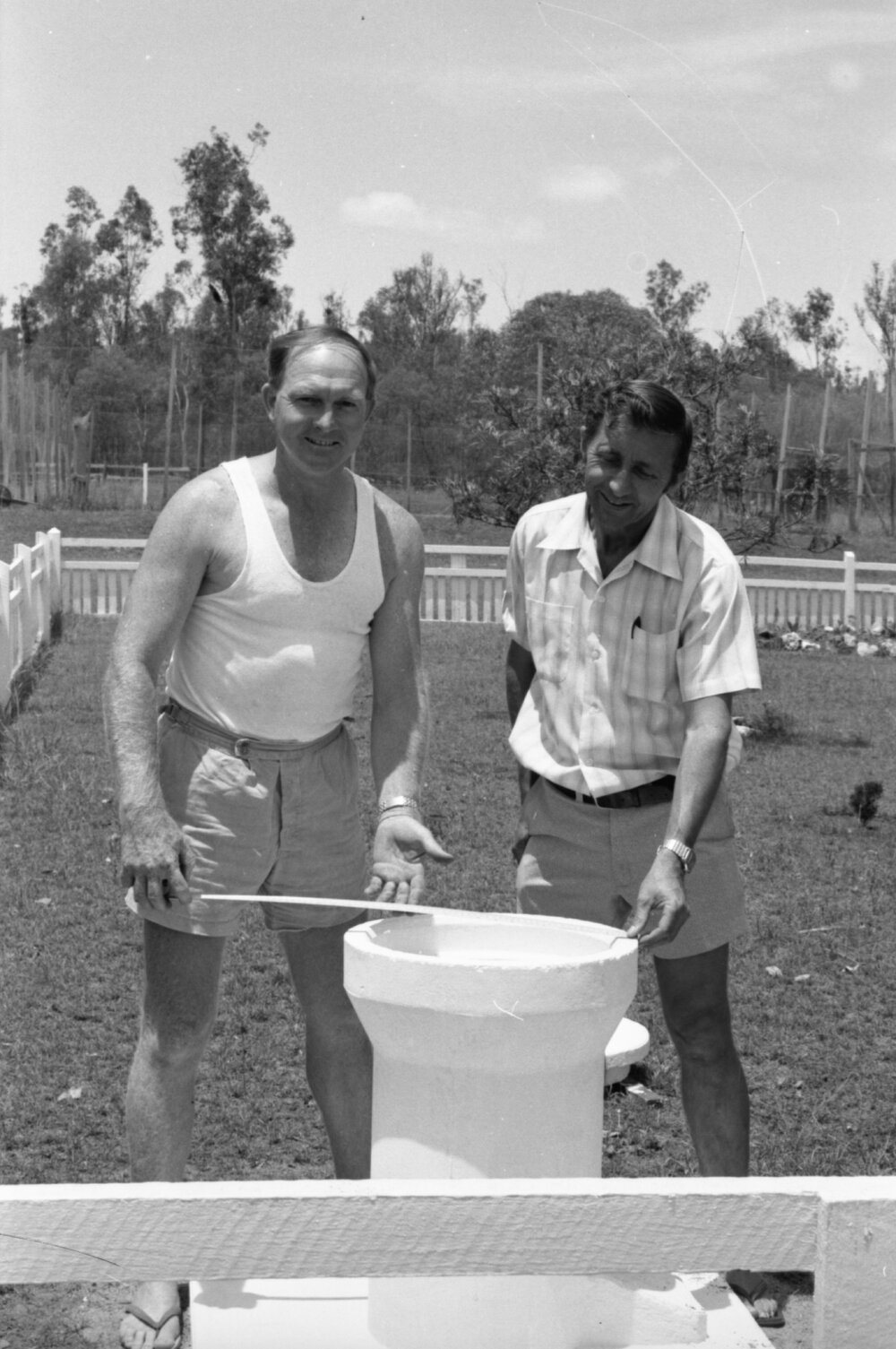 Men checking the sundial pedestal housing for the Grandchester State School Centenary Time Capsule, Grandchester, Ipswich, Queensland, January 1978