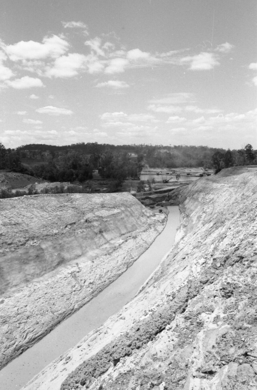 Excavators opening a water channel during the construction of Wivenhoe Dam, Lake Wivenhoe, Somerset, Queensland, January 1978
