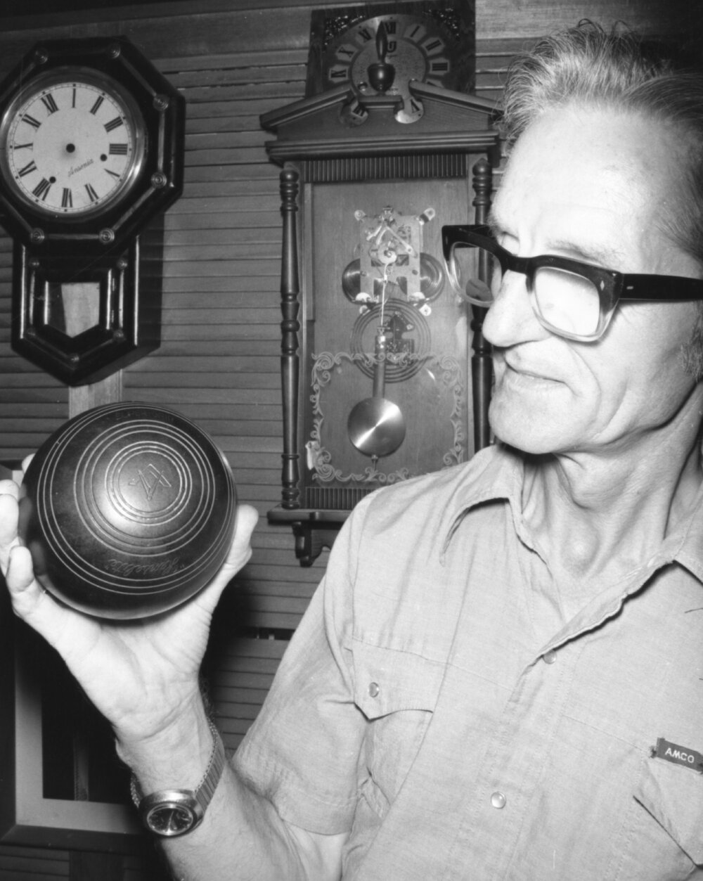 Man with bowls ball and clocks, Ipswich, Queensland, January 1978