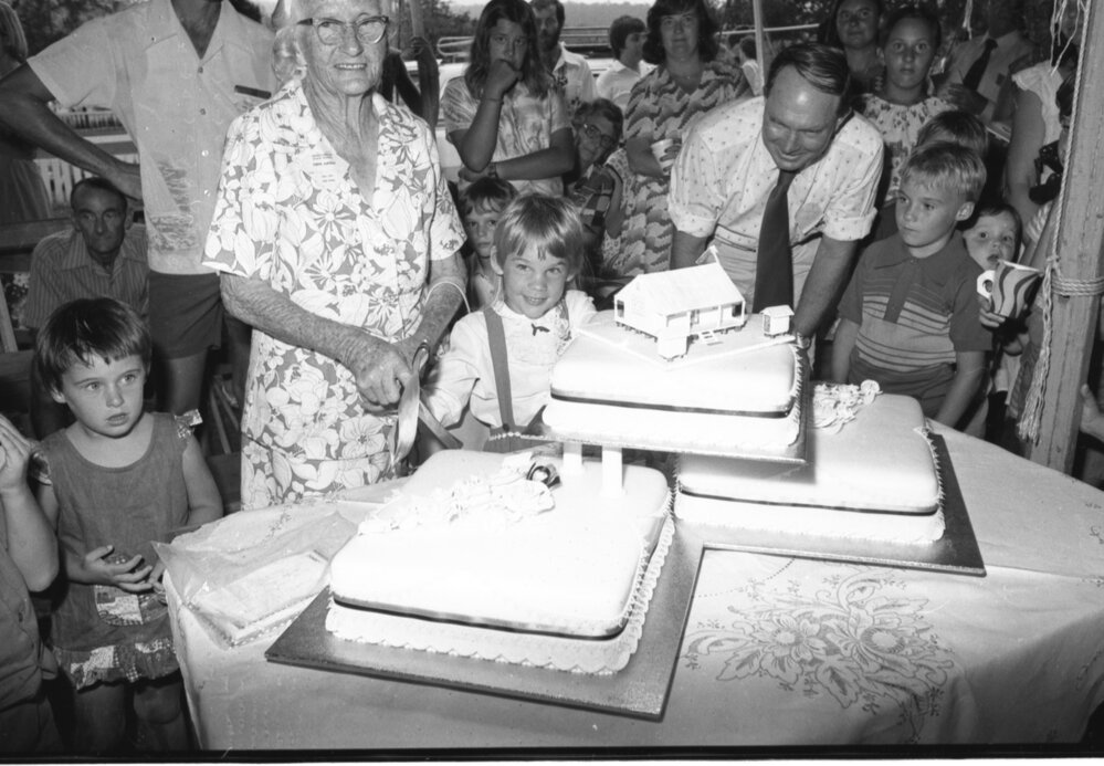 Woman cutting cake at the Grandchester State School centenary celebration, Grandchester, Ipswich, January 1978