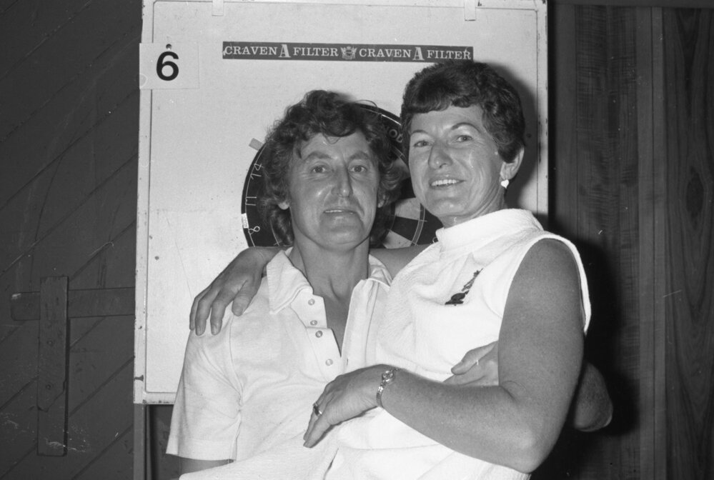 Man and woman with darts board, Ipswich, January 1978