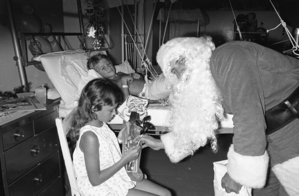 Santa handing out gifts to kids at Ipswich General Hospital, Ipswich, December 1977