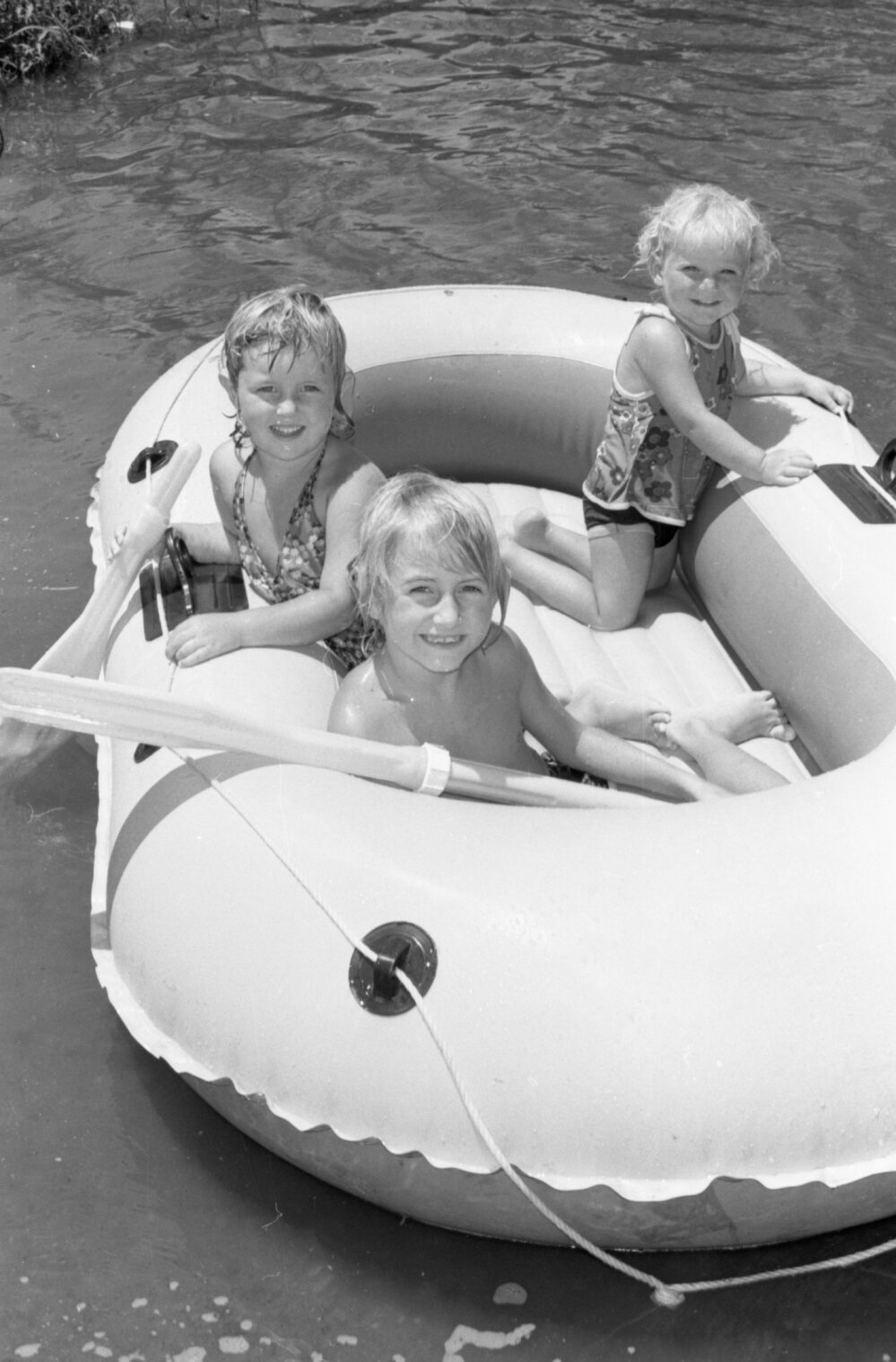 Kids on an inflatable raft at Colleges Crossing, Chuwar, December 1977