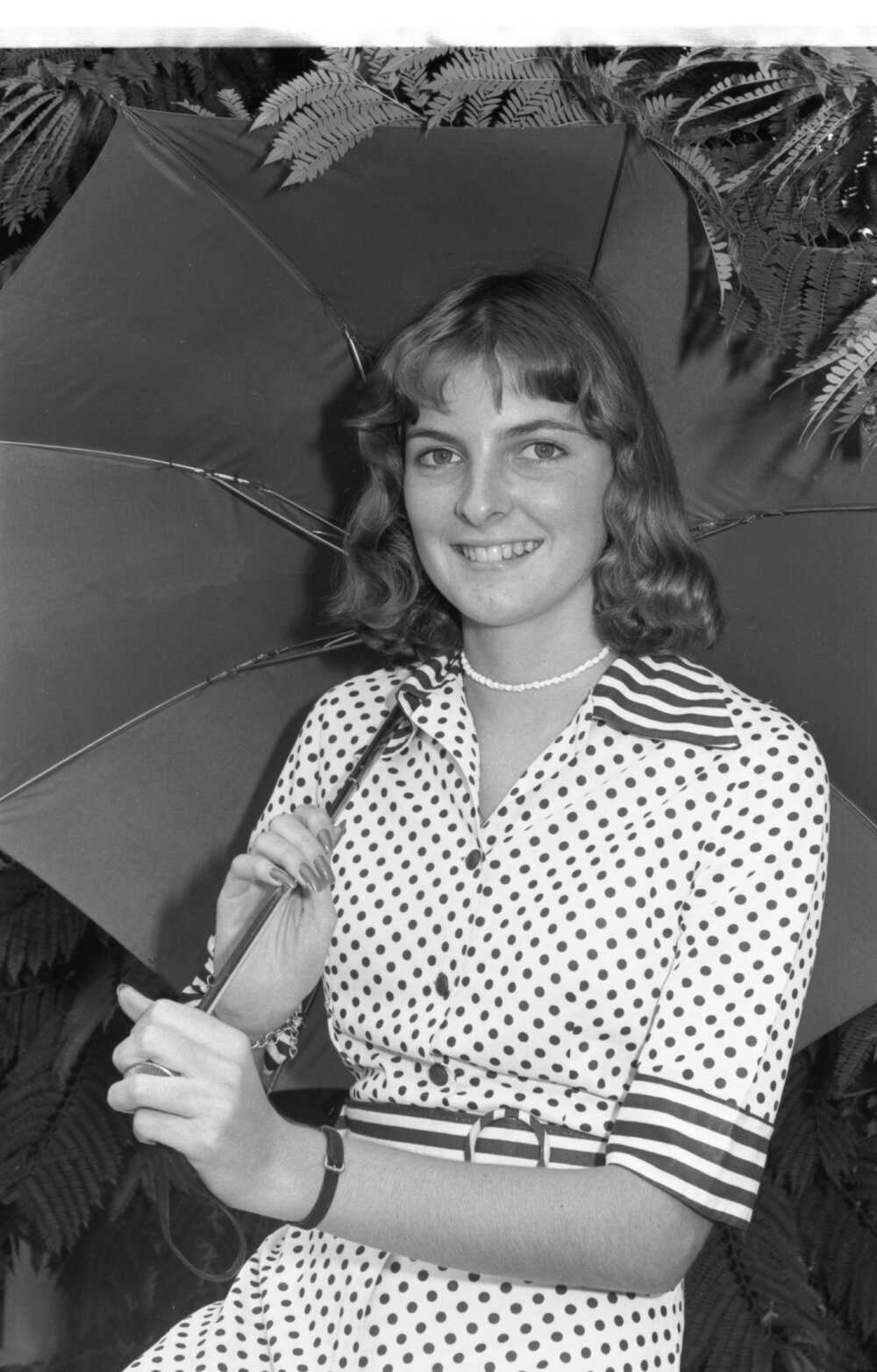 Unidentified woman, thought to be called Helen, in polka dot dress holding an umbrella, Ipswich, February 1978