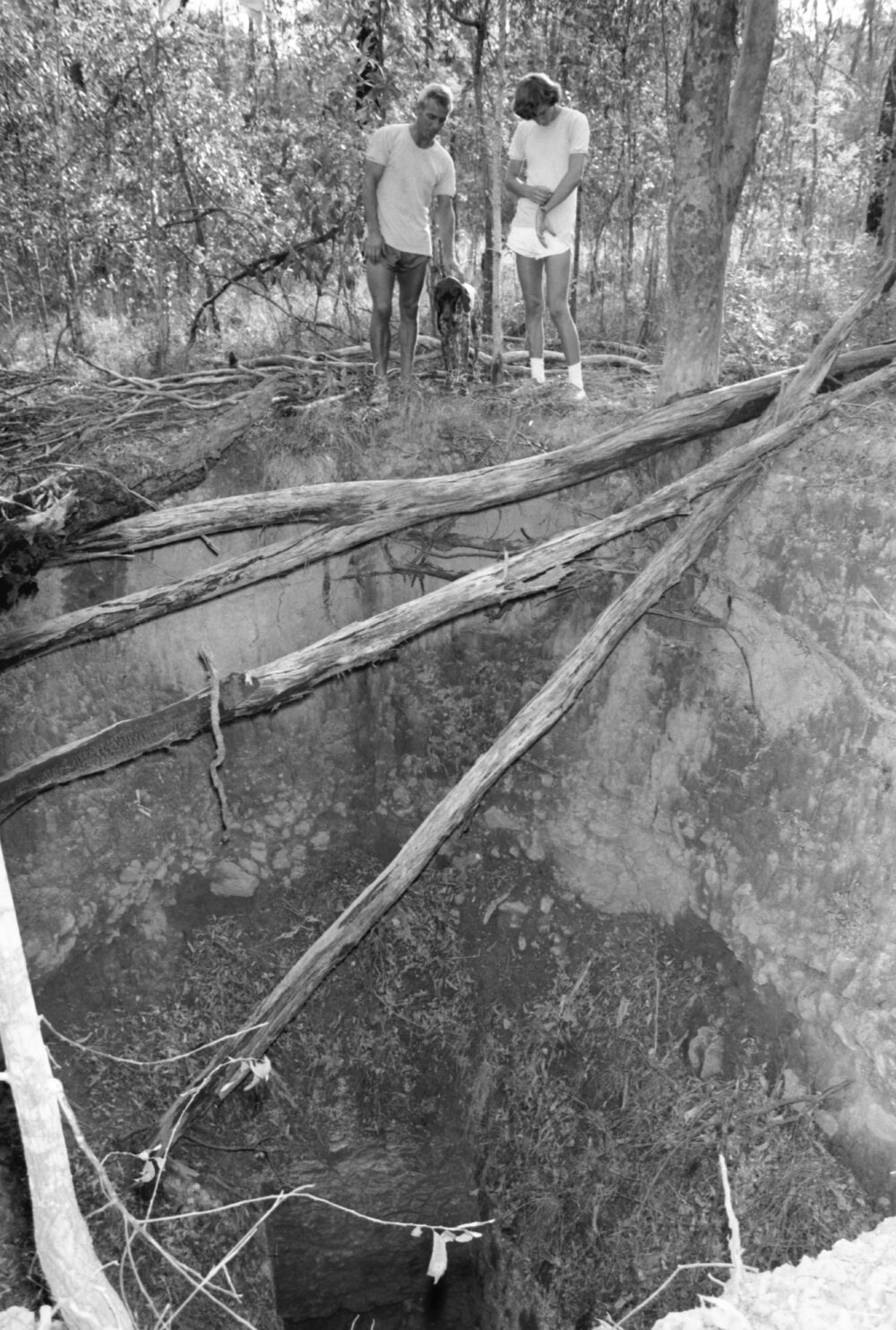 Unidentified men standing over mining shaft, Ipswich, Queensland, February 1978