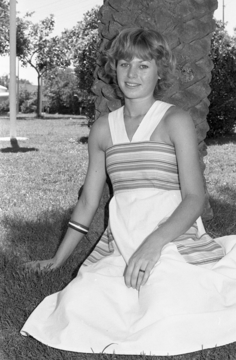Unidentified young woman sitting in Memorial Gardens, Ipswich, February 1978