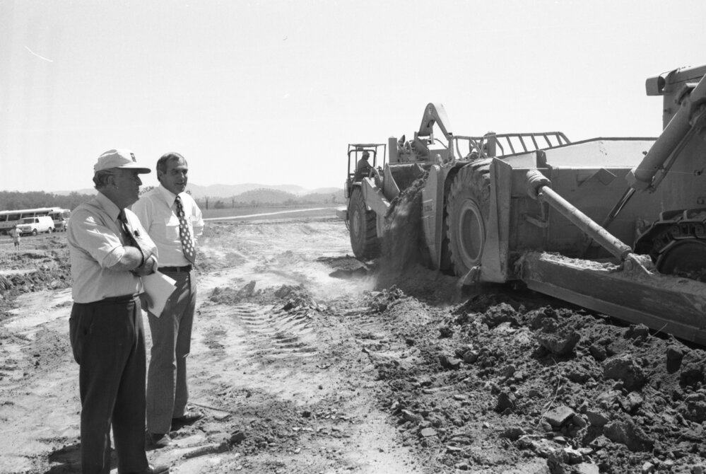 Premier Joh Bjelke-Petersen and unidentified man oversee construction of Wivenhoe Dam, Somerset, February 1978