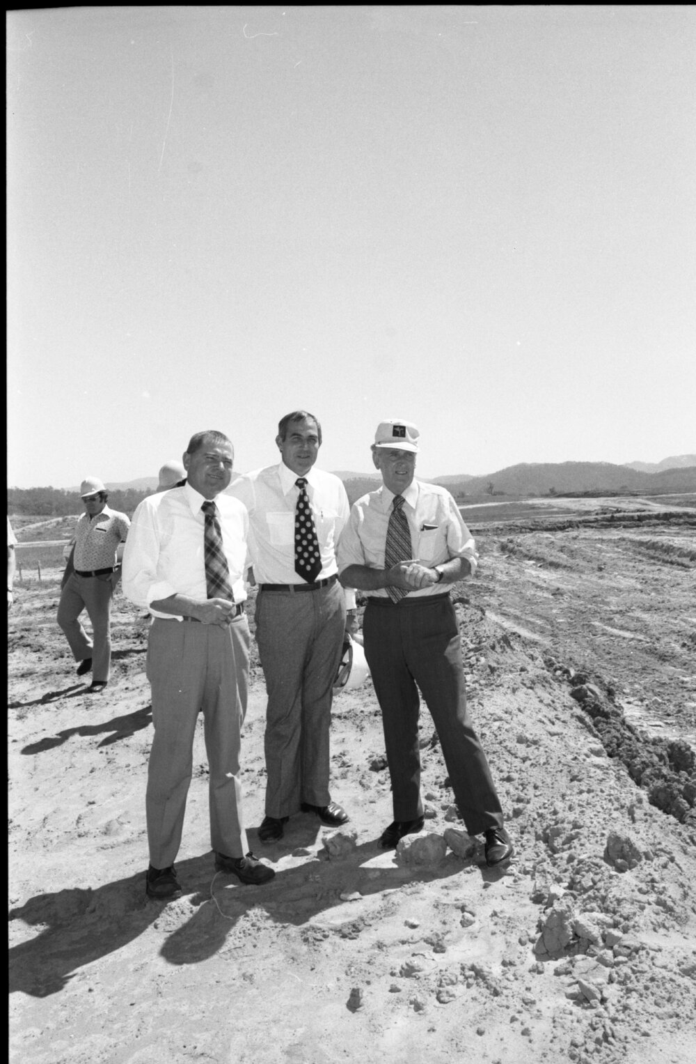 Premier Joh Bjelke-Petersen and two unidentified men at the construction site of Wivenhoe Dam, Somerset, Queensland, February 1978