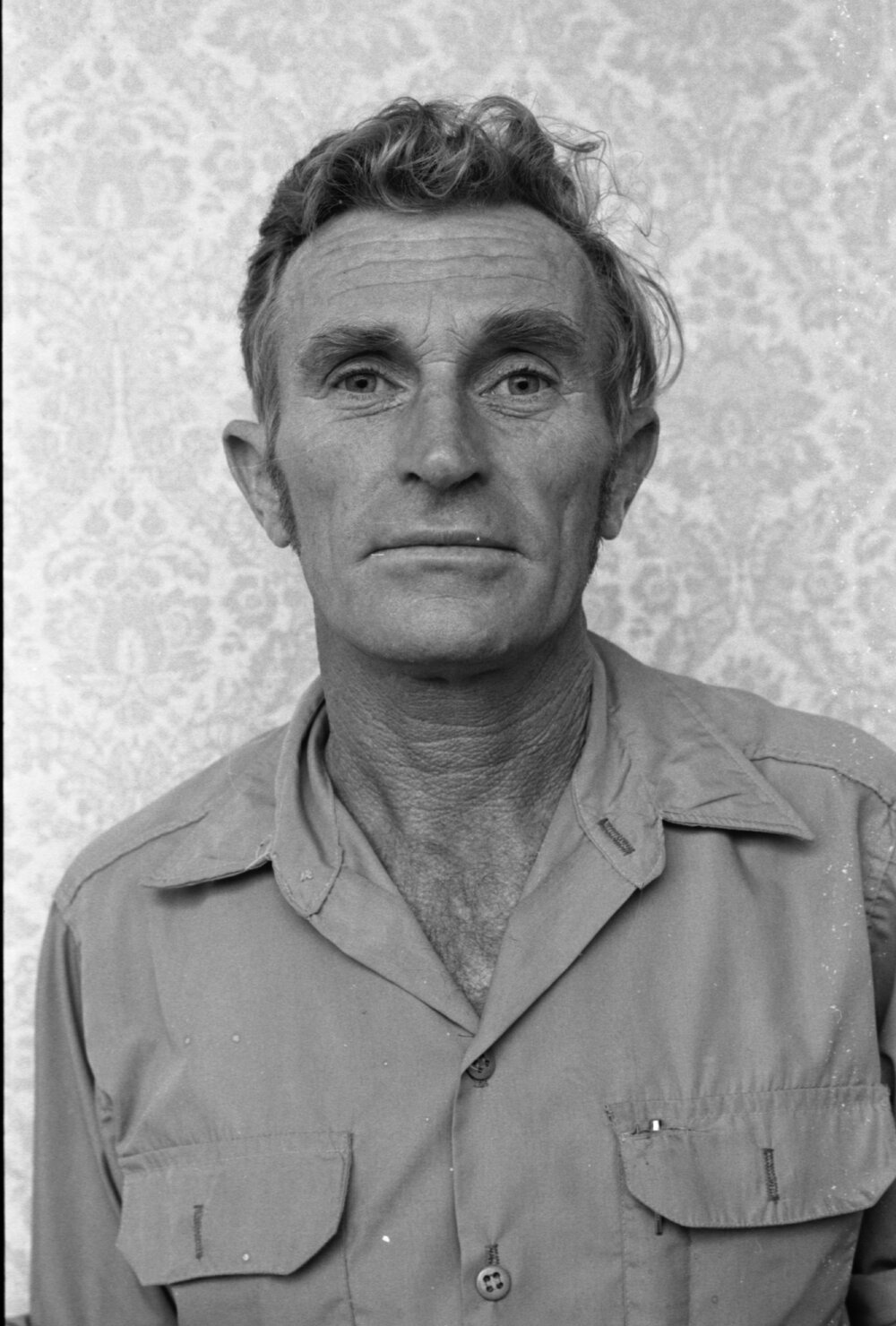 Unidentified man in workwear examining a ceiling, Ipswich, Queensland, February 1978