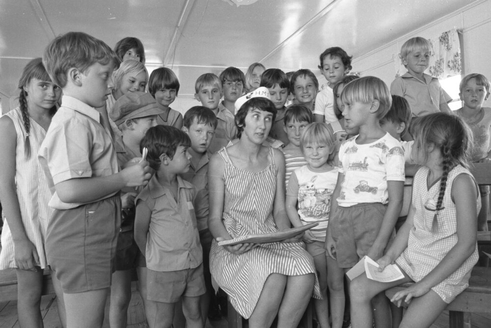 Unidentified woman in sailor hat reading to a group of children for a Church of Christ program, Ipswich, February 1978