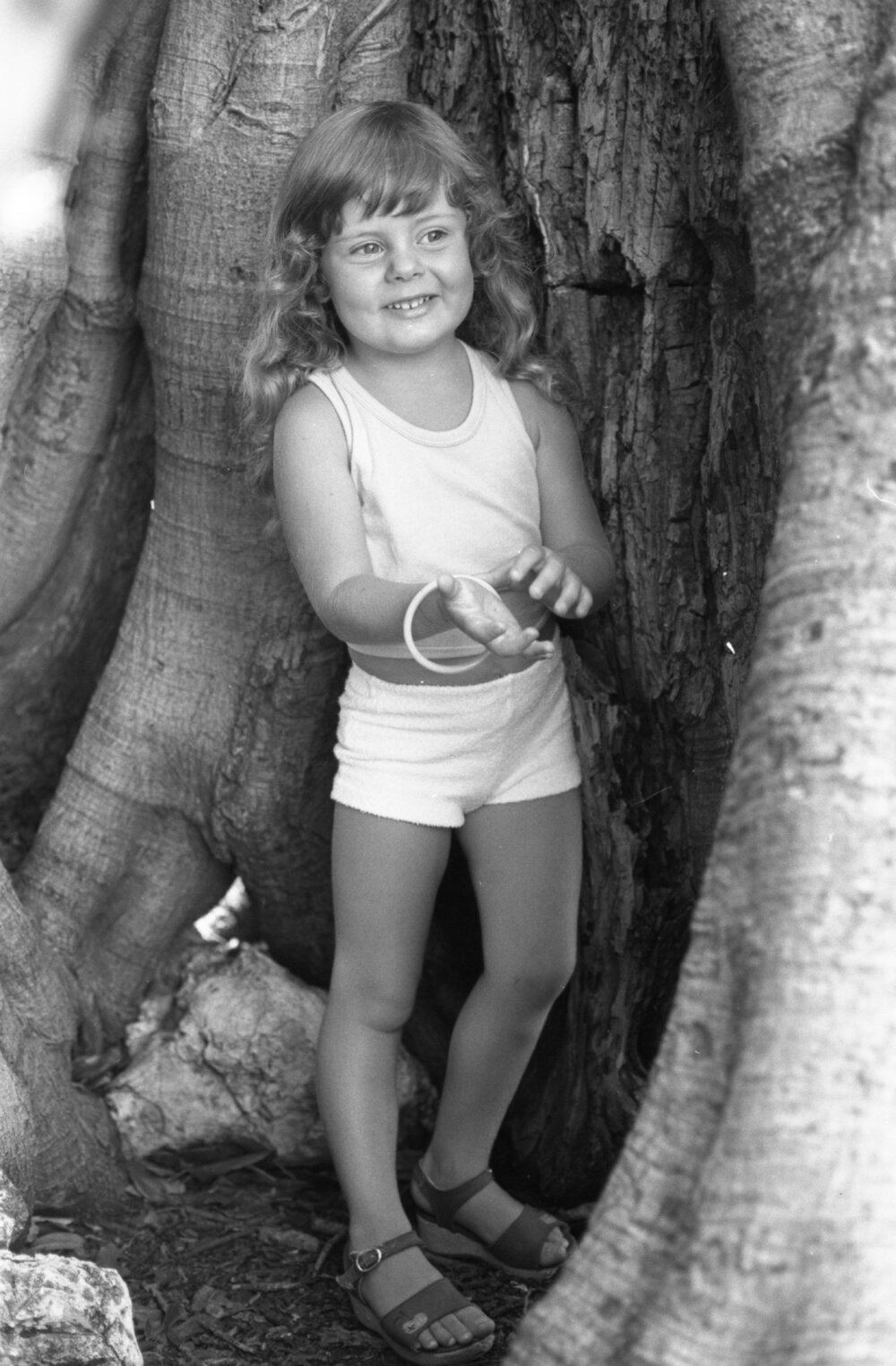 Unidentified girl posing under a large Moreton Bay fig tree in Queens Park, Ipswich, February 1978