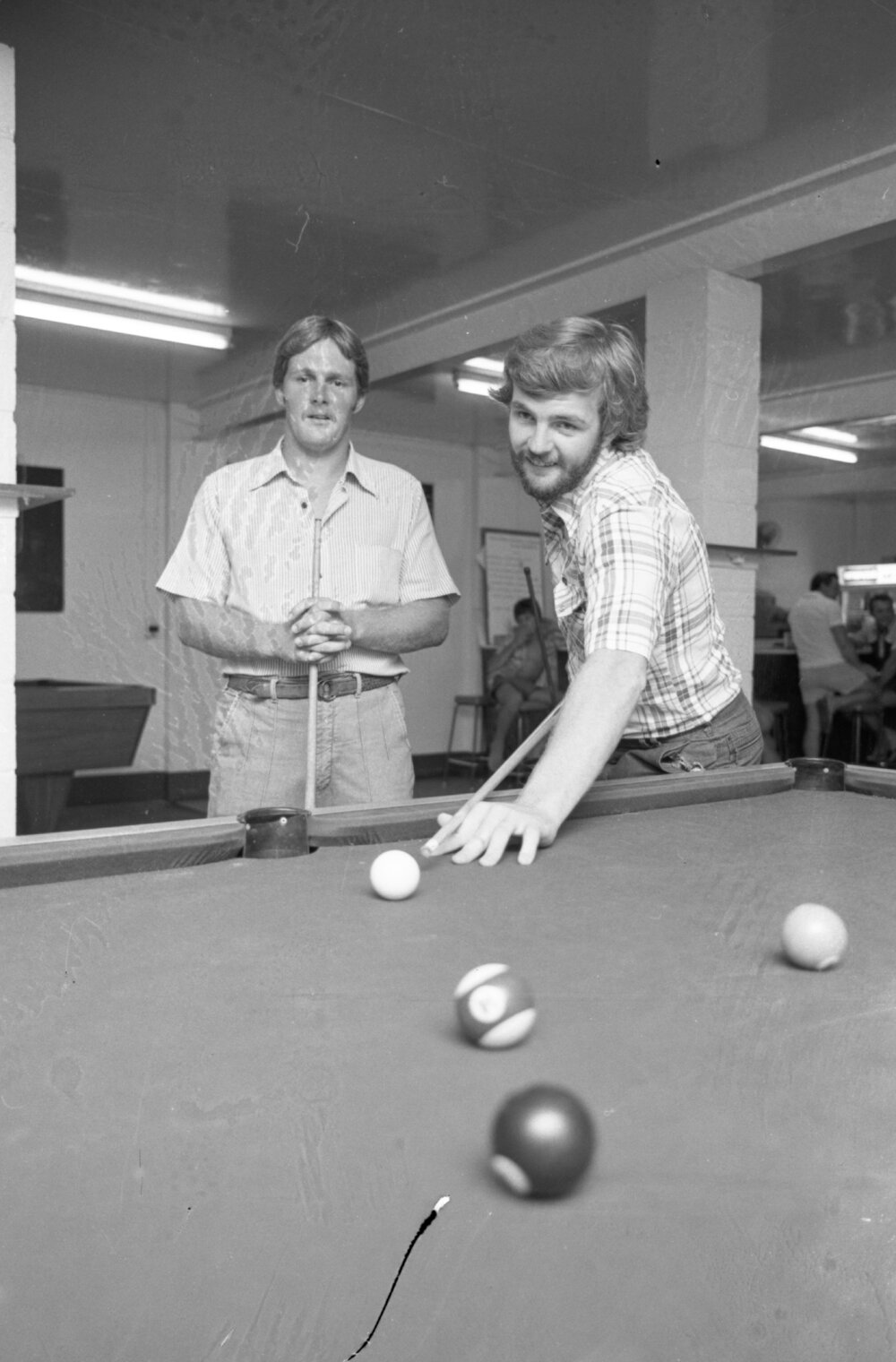 Two unidentified men playing on a pool table, Ipswich, February 1978