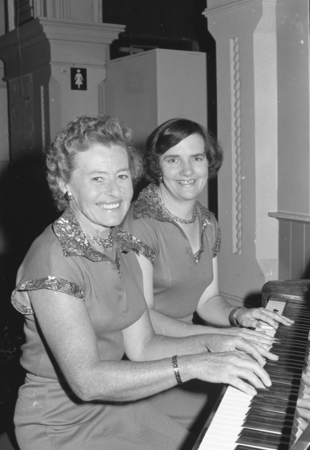 Two unidentified women playing the piano, Ipswich, Queensland, February 1978