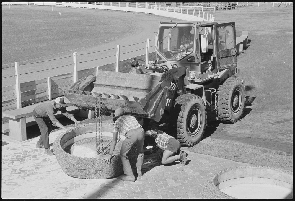 Unidentified people moving concrete garden bases with a Michigan Loader 35B most likely at the Gatton Show Grounds, Gatton, July 1985
