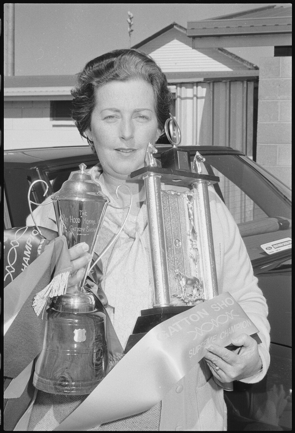Unidentified lady with Equestrian trophy, the Ray Hood Memorial Trophy and banners, Gatton Show, Gatton, July 1985