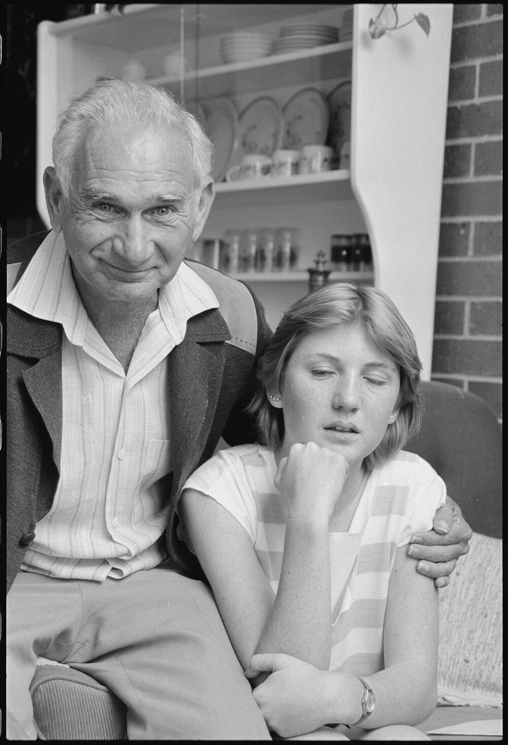 Unidentified man young woman at home after cleaning his kitchen from a fire, Ipswich, July 1985