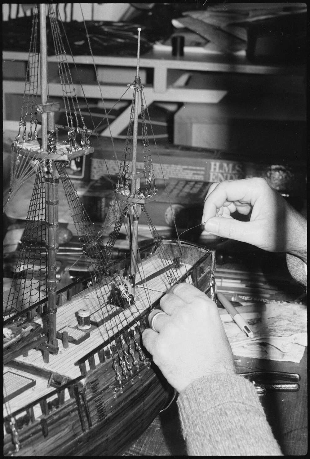 Unidentified model builder building a model of the HMS Endeavour 1768, Ipswich, July 1985