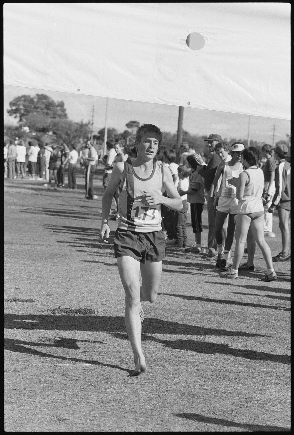 Unidentified runner competing bare footed at a District Cross Country event, Limestone Park, Ipswich, July 1985
