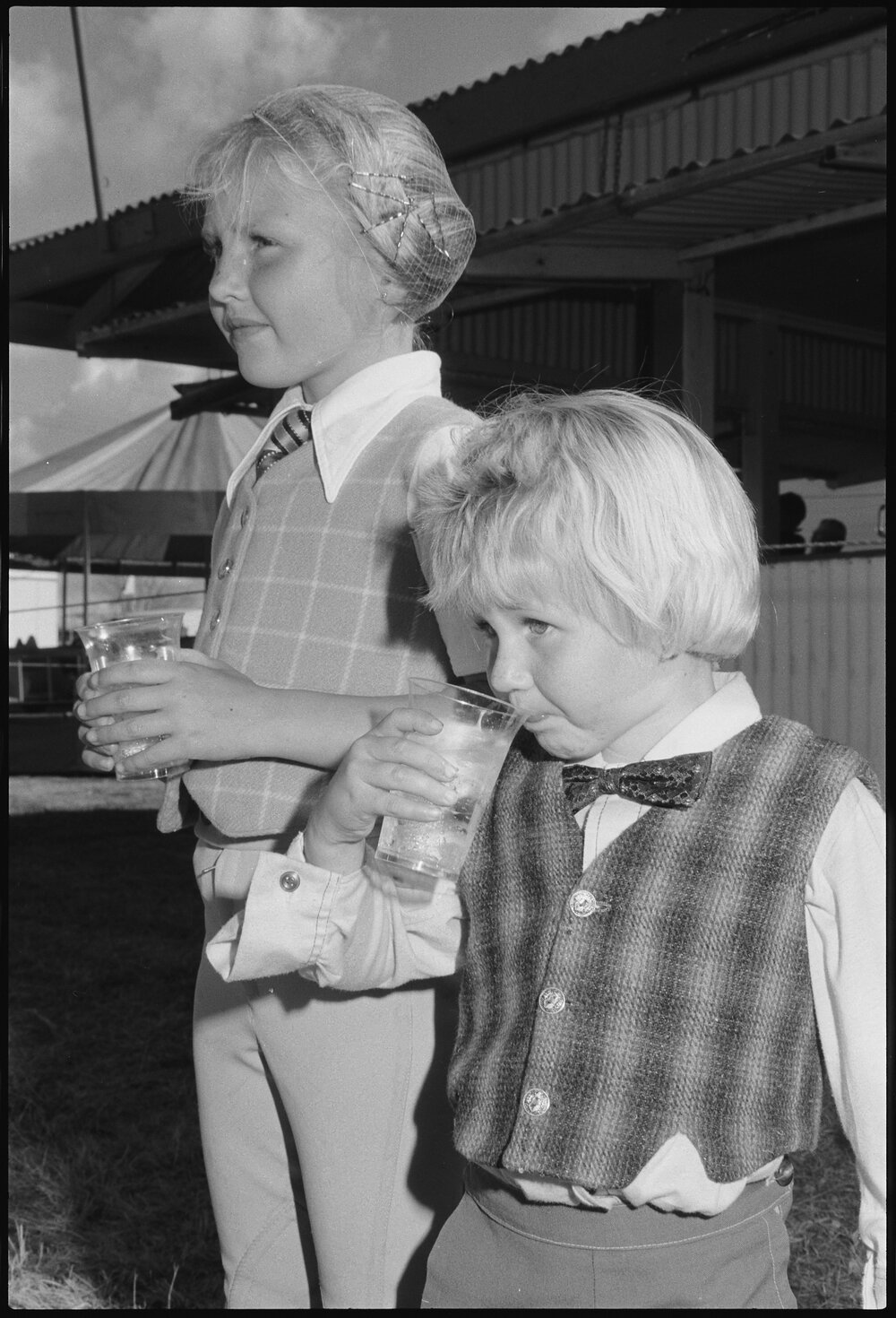Two unidentified children drinking water, Ipswich, July 1985
