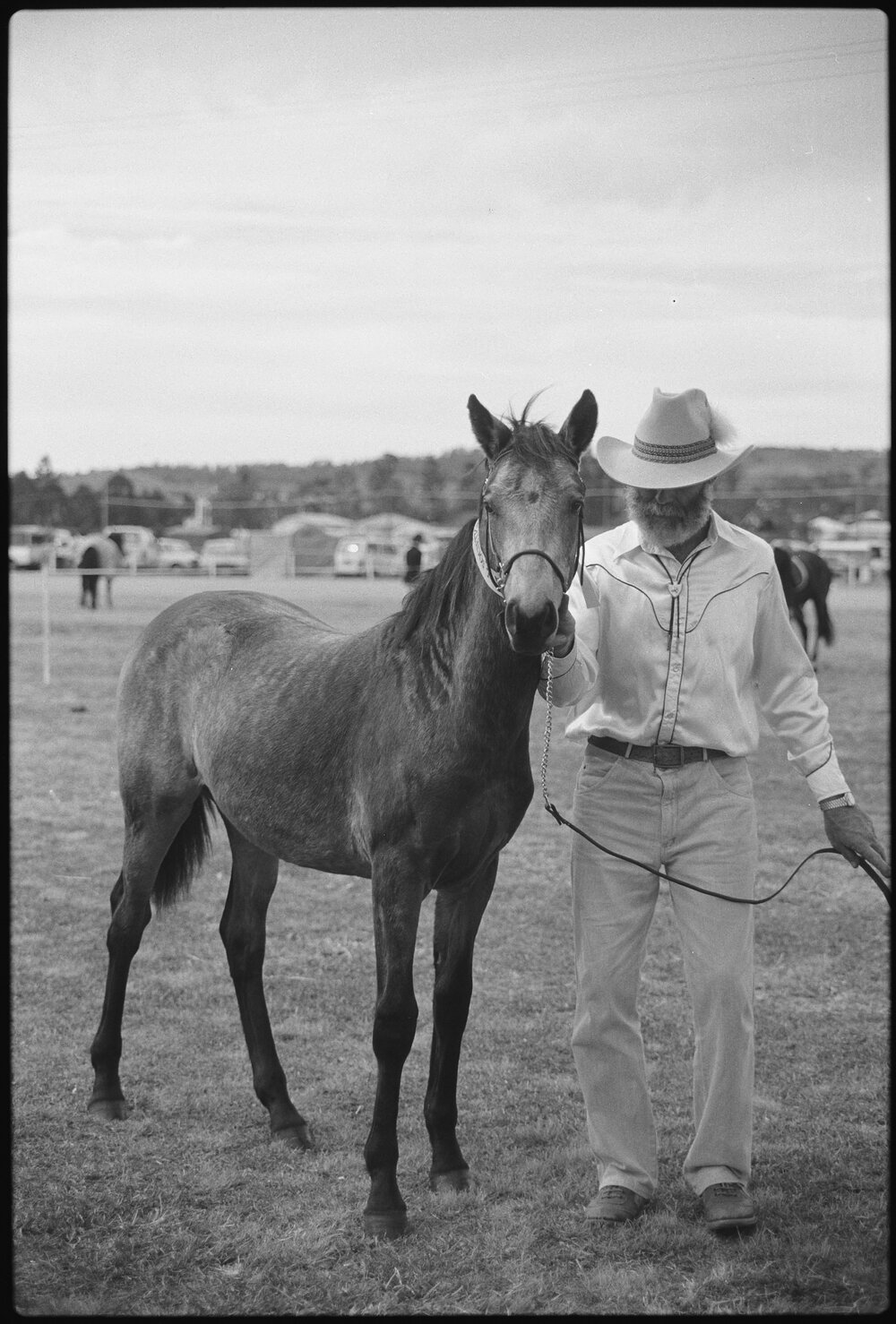 Unidentified man with a horse at a horse event, Ipswich, July 1985 