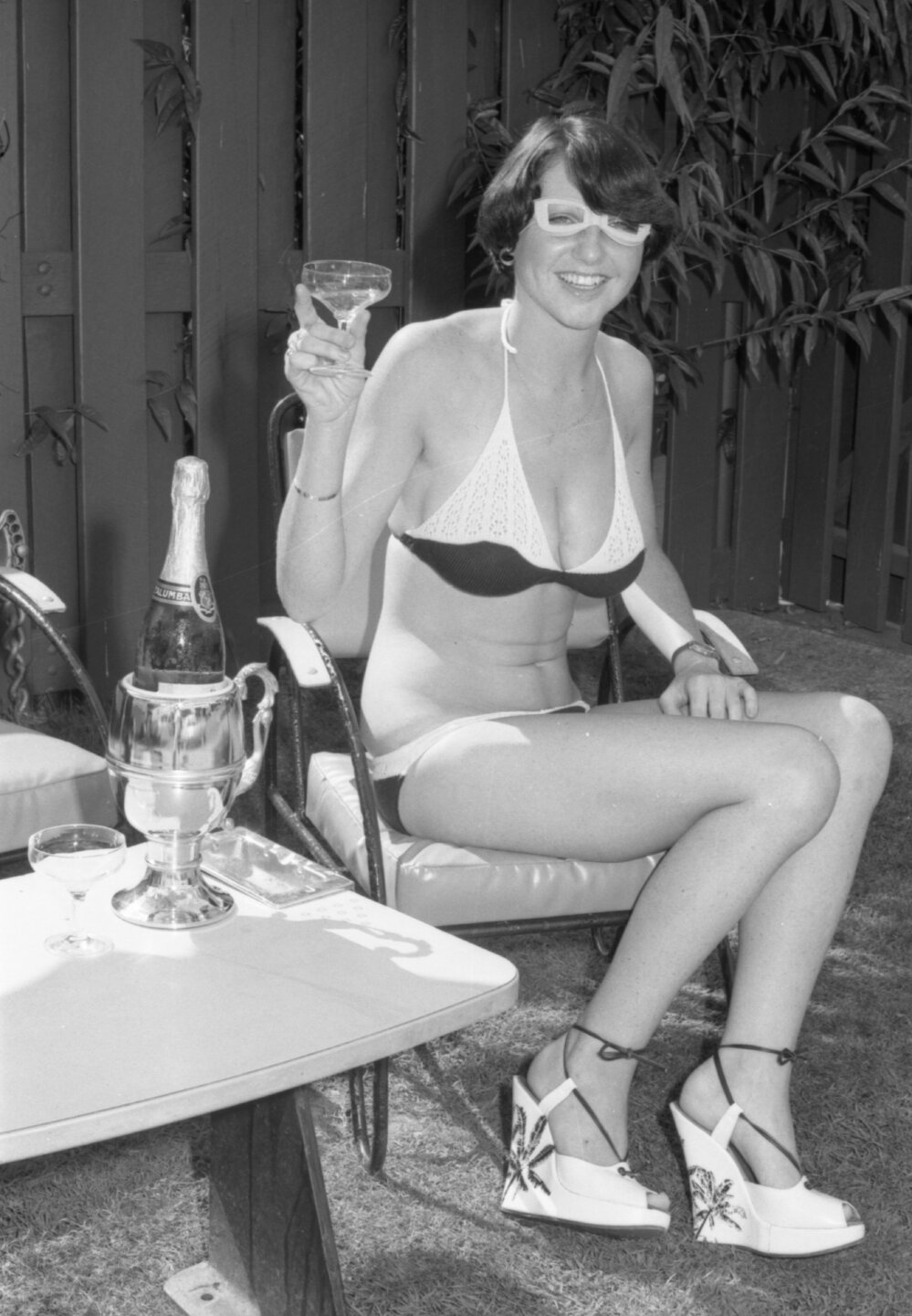 Woman posing with wine, Ipswich, November 1977