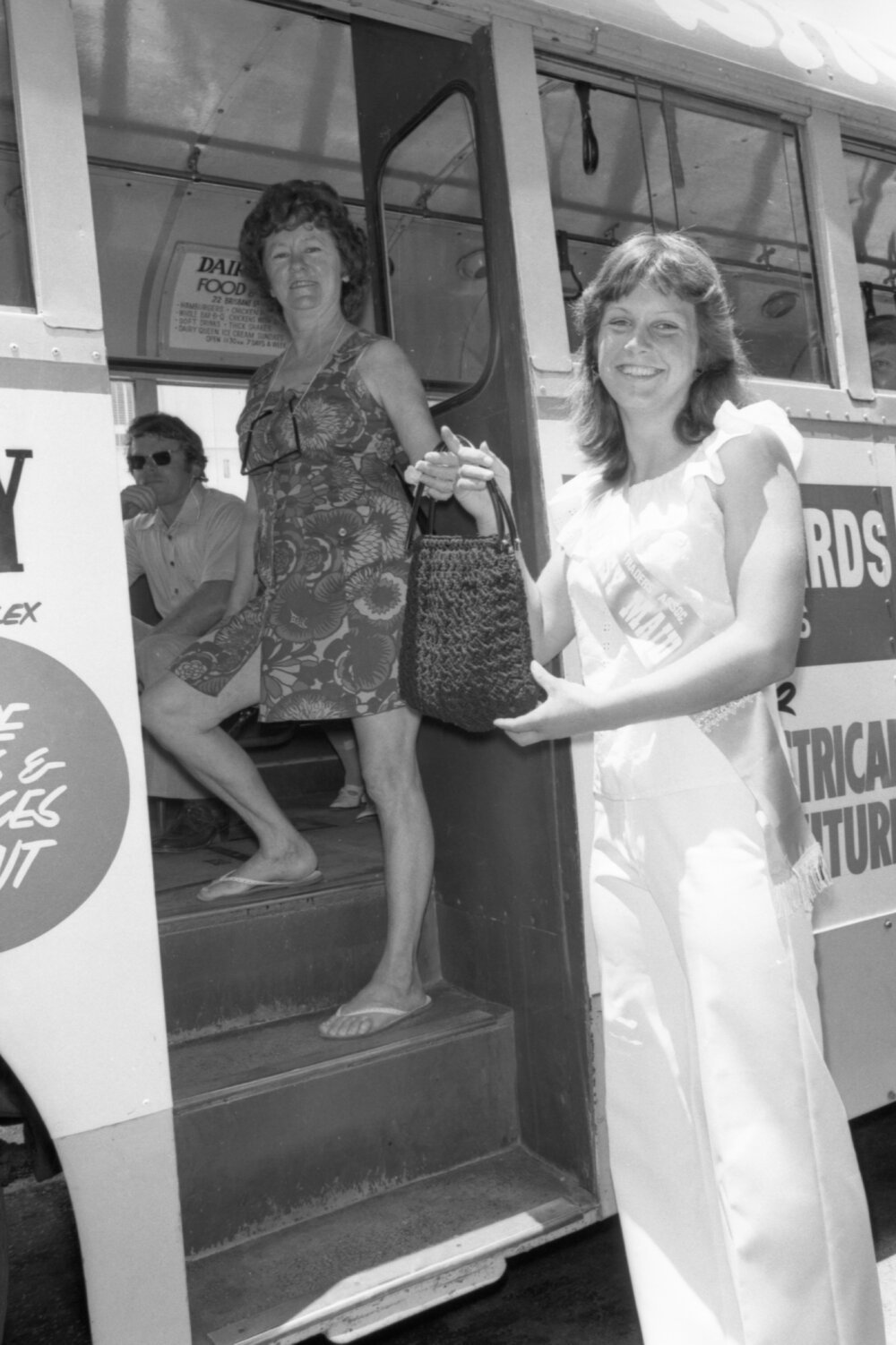 Unidentified Courtesy Maid helping woman boarding a bus, Ipswich, November 1977